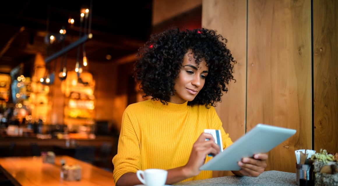 woman using digital tablet at the bar.