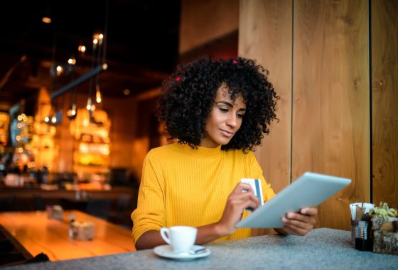 woman using digital tablet at the bar.