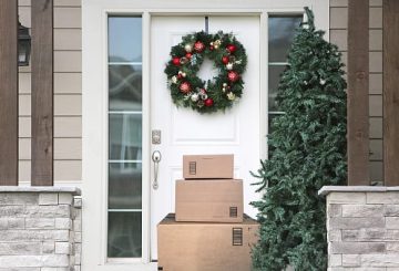 front door with christmas wreath and packages