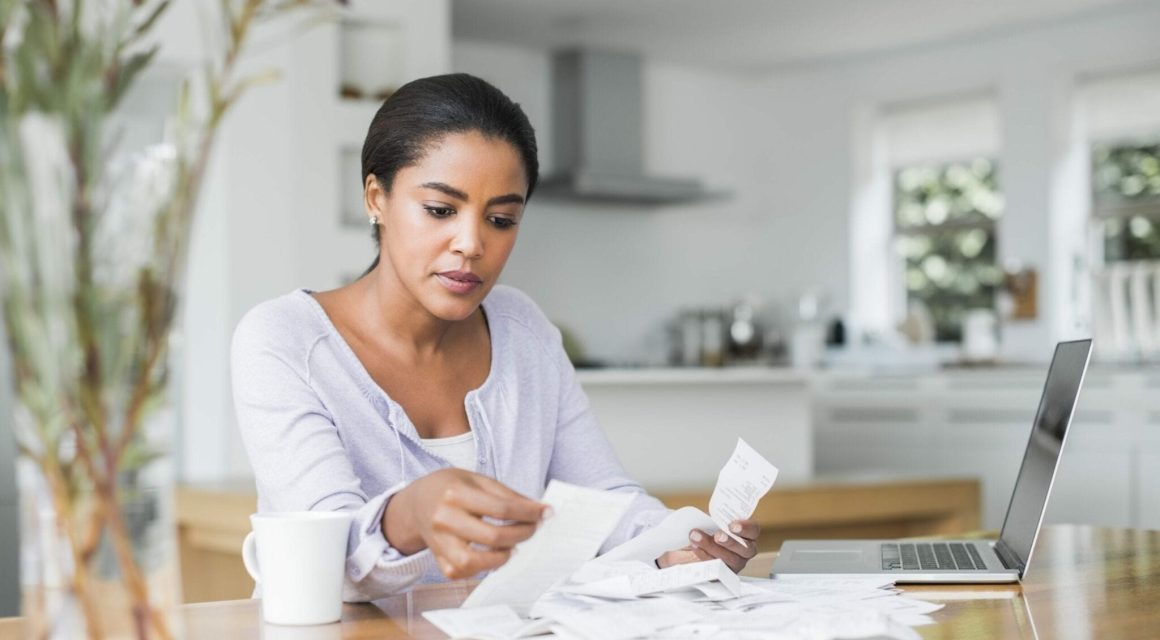 Woman paying bills online at home