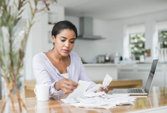Woman paying bills online at home