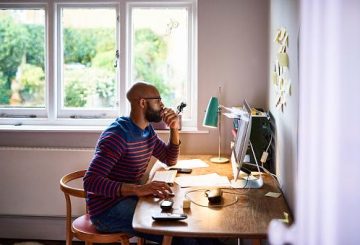Man using computer at a desk at home