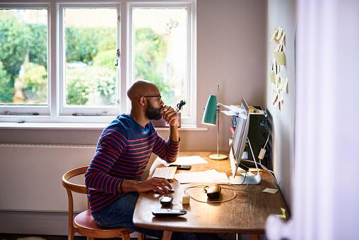 Man using computer at a desk at home