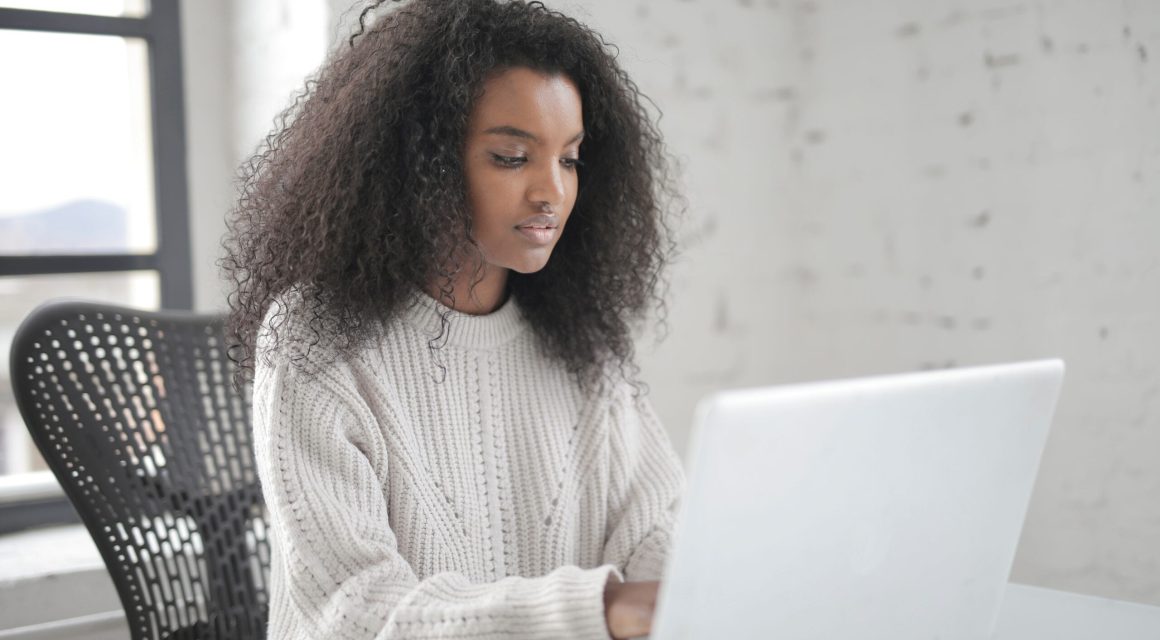 Young woman typing on laptop.