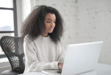 Young woman typing on laptop.