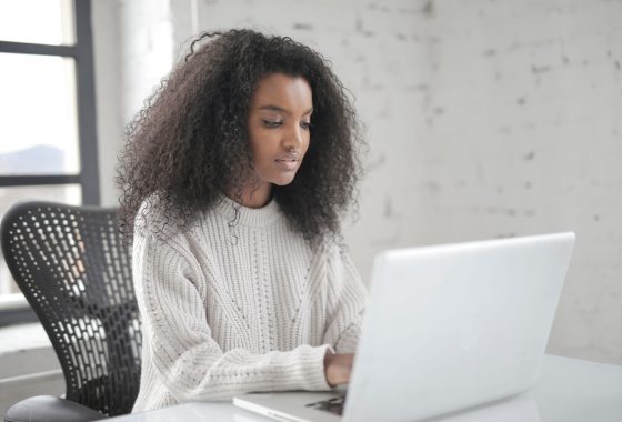 Young woman typing on laptop.