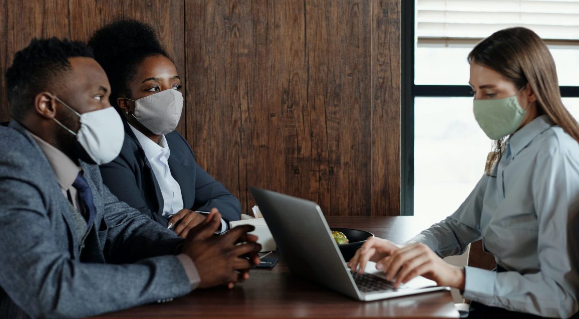 People having a meeting with masks on