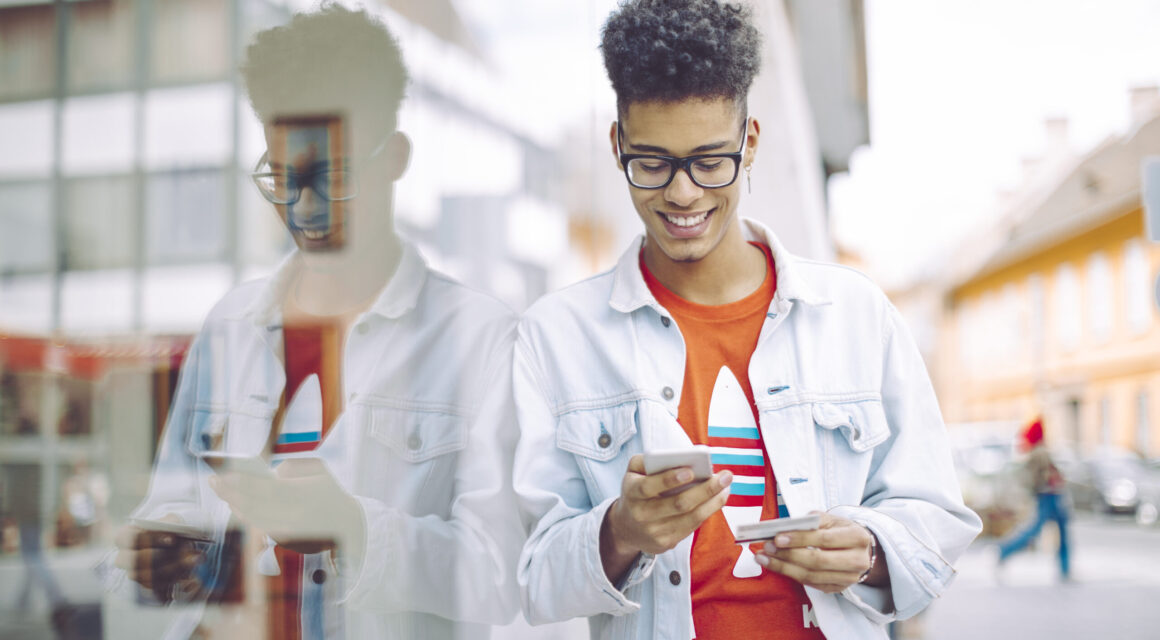 Young man using phone in the city