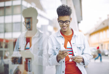 Young man using phone in the city