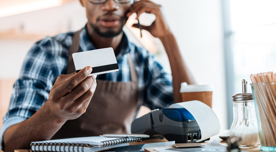 man looking at credit card