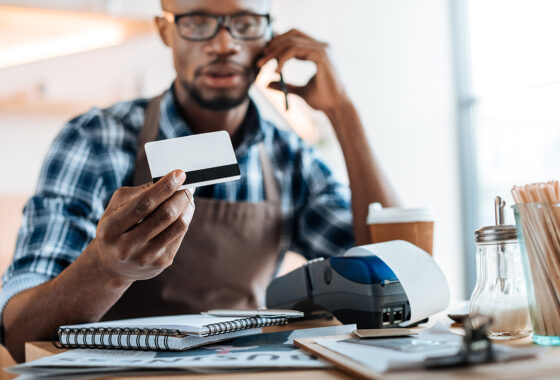 man looking at credit card