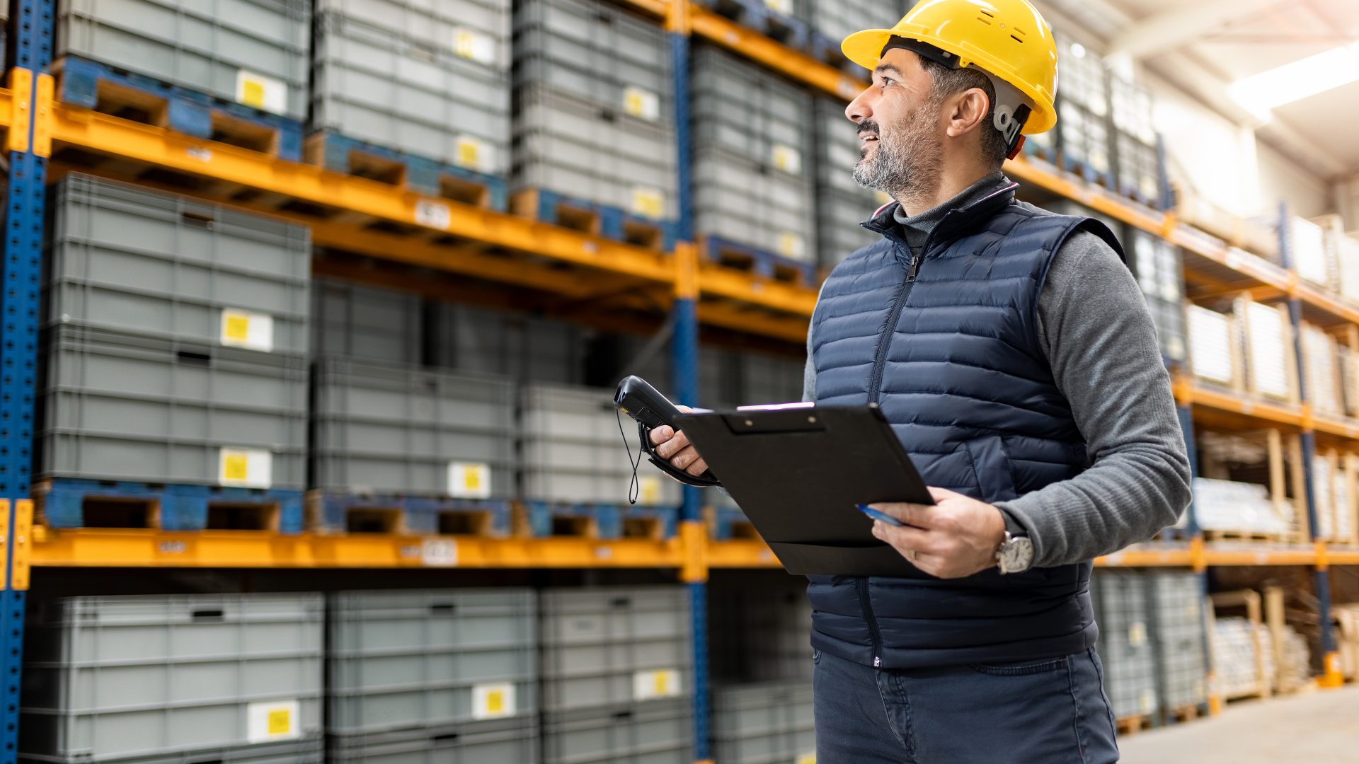 Adult man working in factory warehouse.