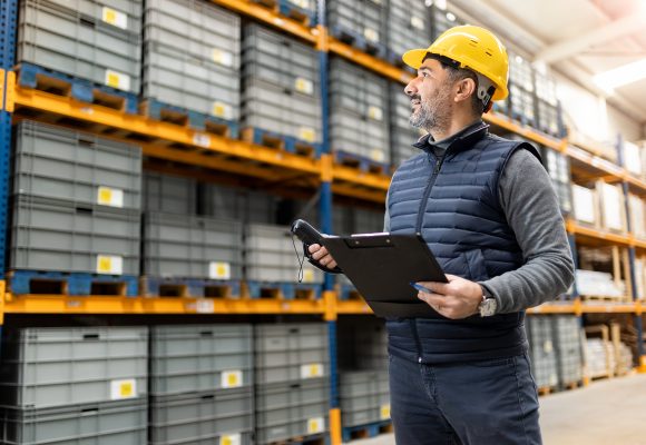 Adult man working in factory warehouse.