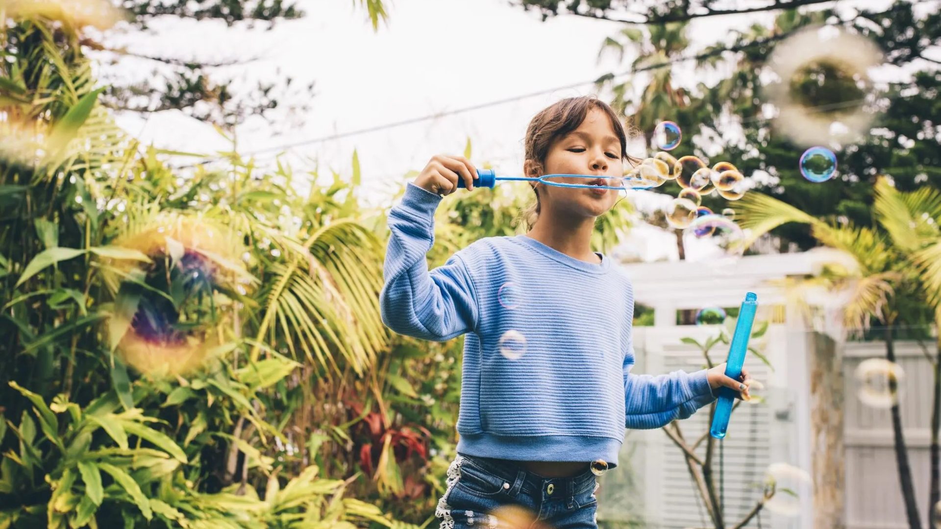 child blowing bubbles