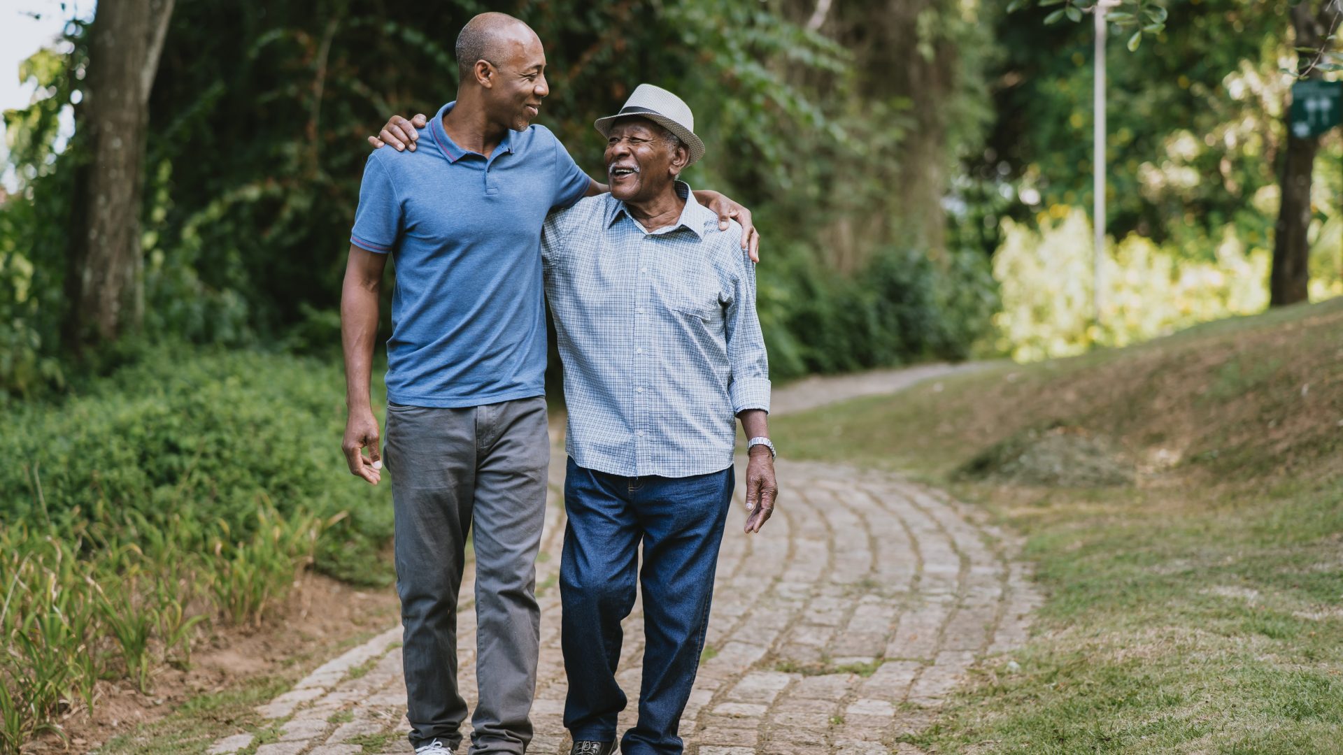 Portrait of elderly father and adult son walking