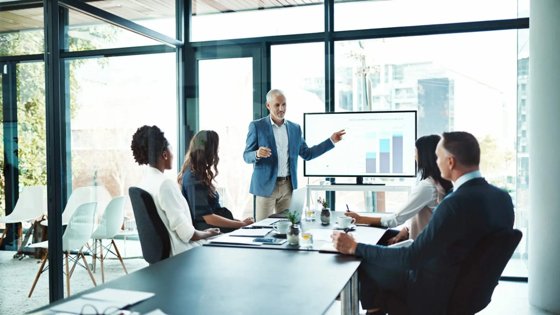 people sitting in a meeting watching a presentation