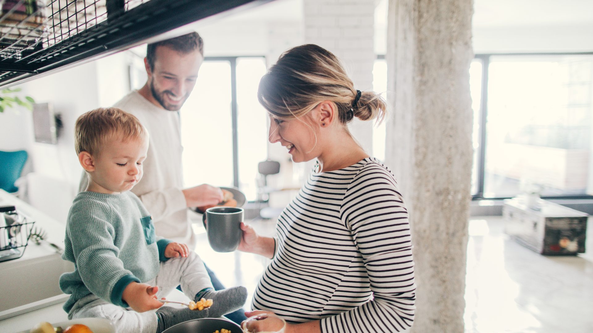 Photo of a young family preparing breakfast together in their kitchen