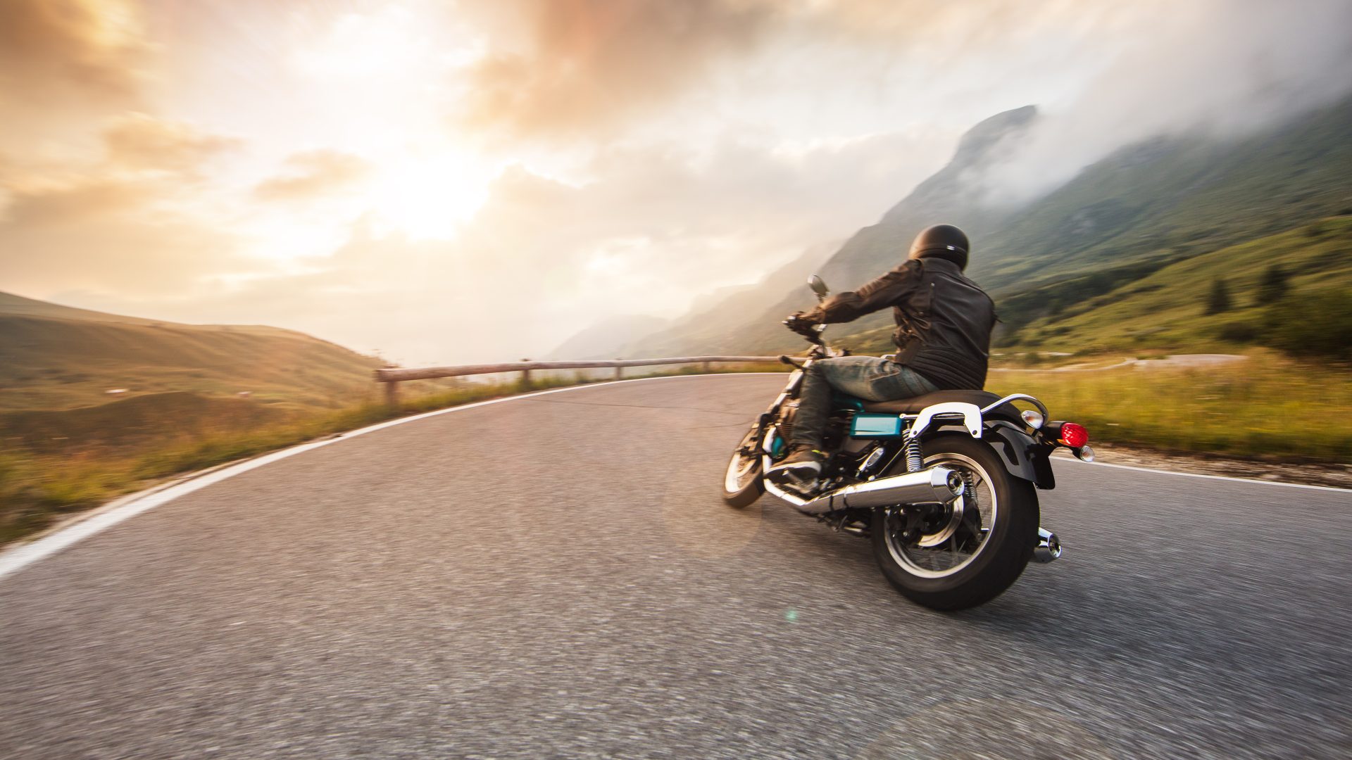 Motorcycle driver riding in Dolomite pass, Italy, Europe.