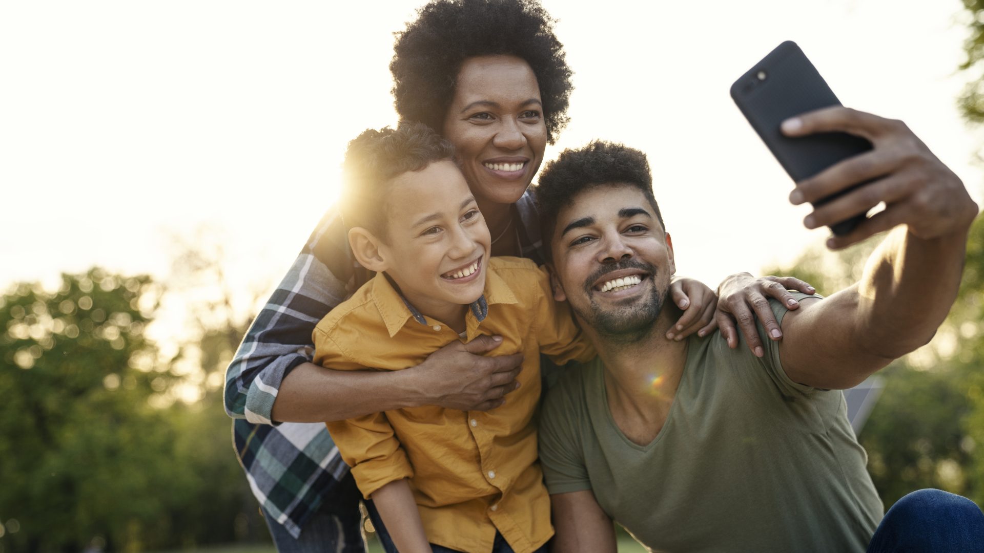 Happy family in the park taking selfie