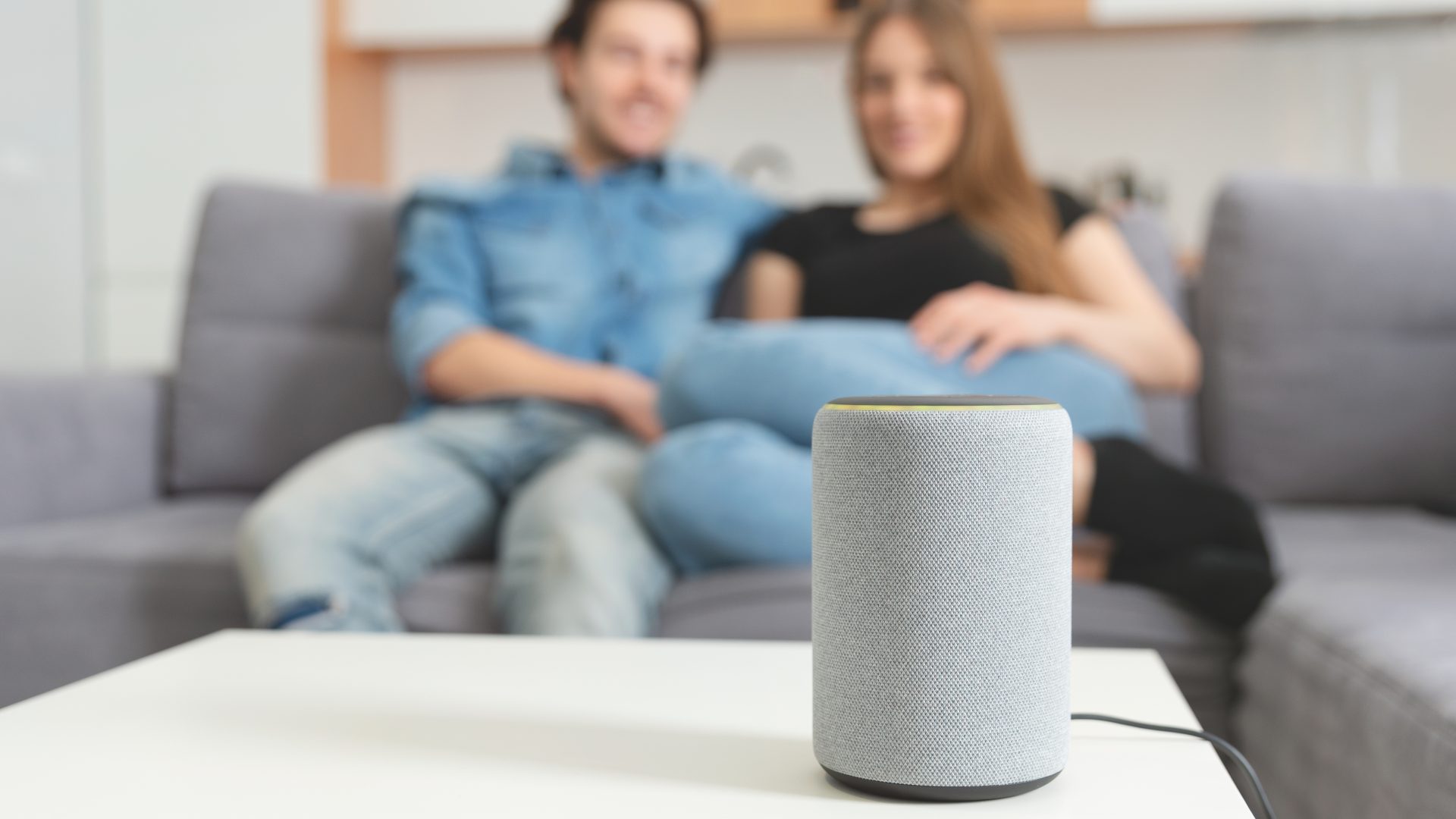 Couple talkinCouple talking command to smart speakerg command to smart speaker