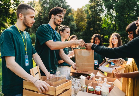 A couple is taking a bag of food at the food and clothes bank