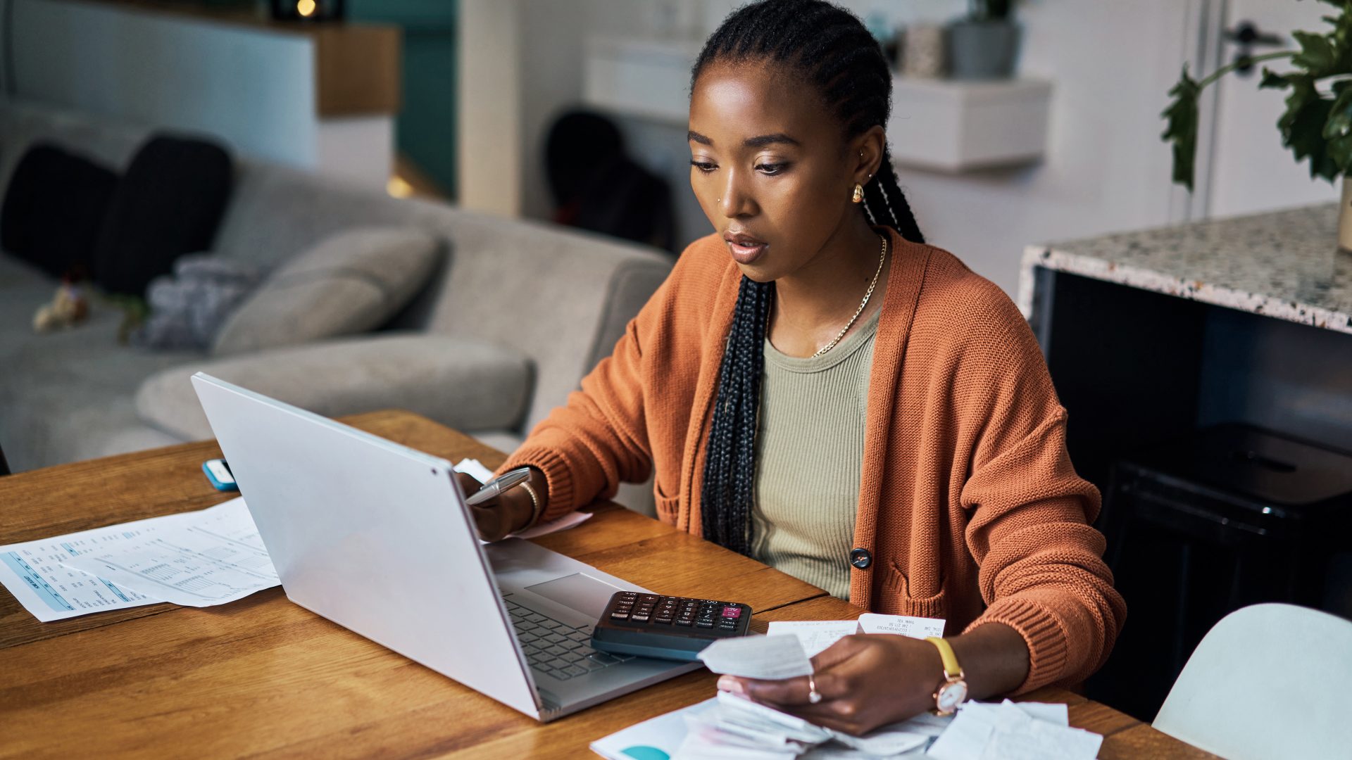 Black woman, budget and home finance on laptop for accounting, money planning and fintech investment. Paper bills, savings and web payment review, online banking and insurance loan of financial taxes