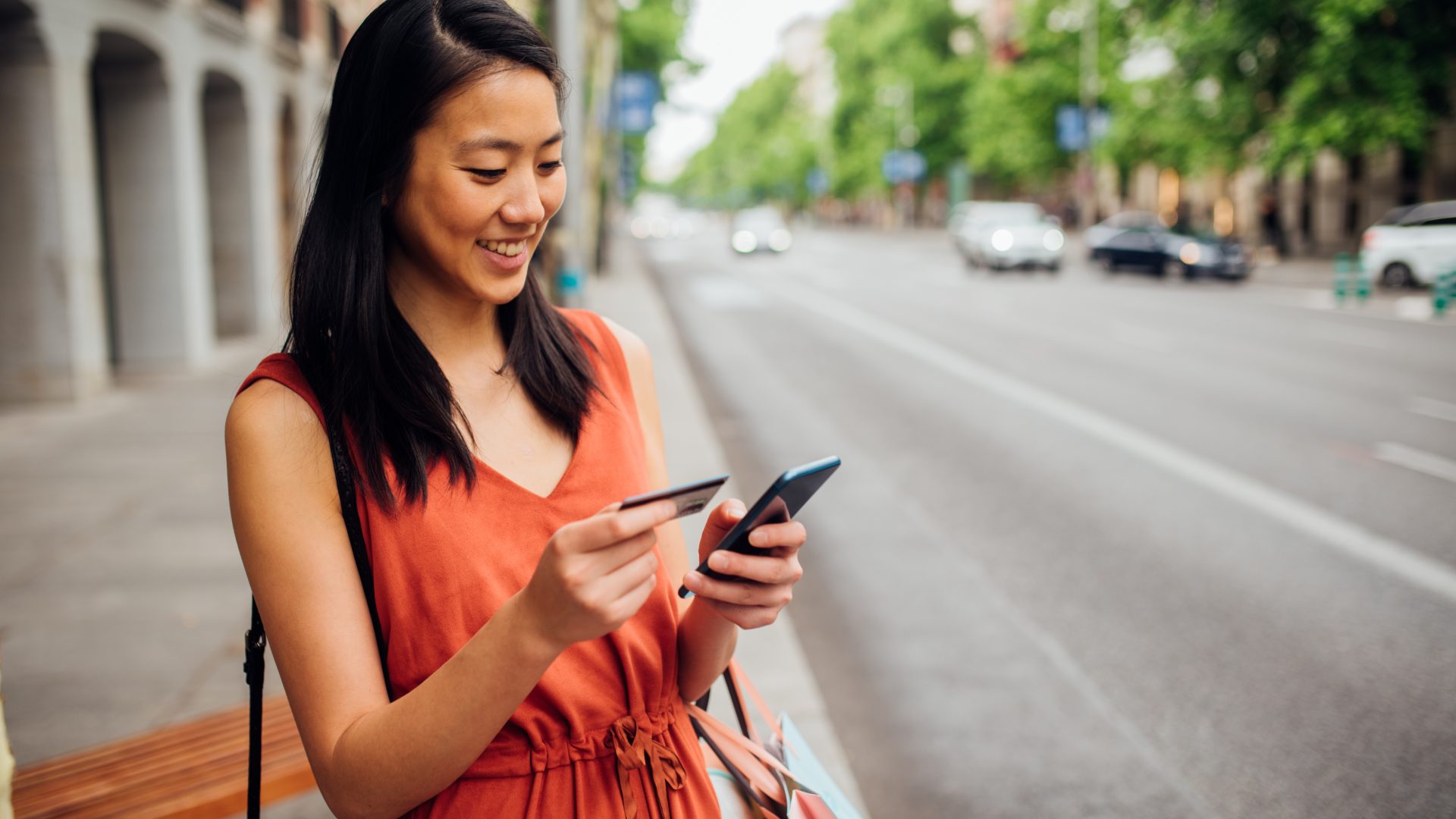 Asian girl shopping online on the street