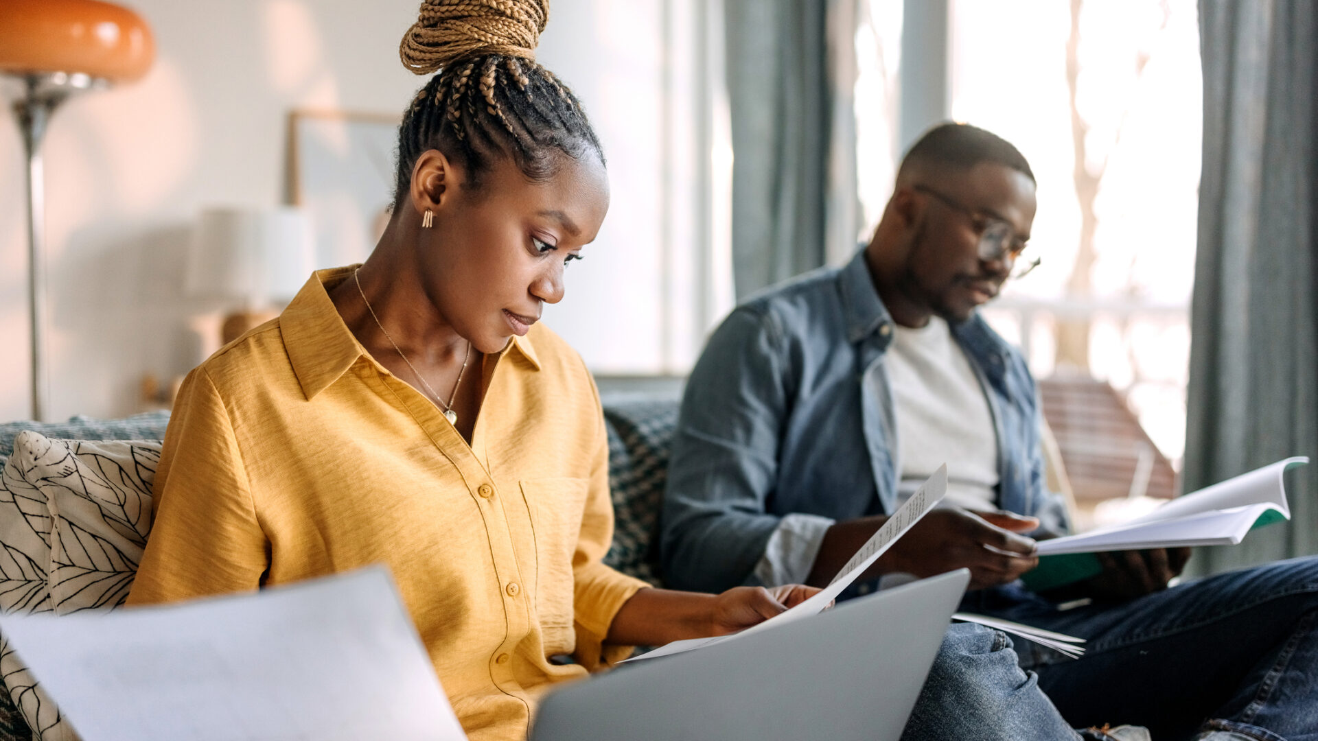 Couple working together at home, going over paperwork