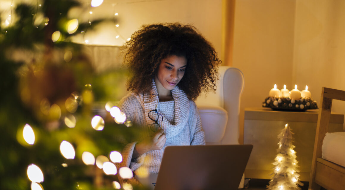 Black girl alone working for Christmas in her living room