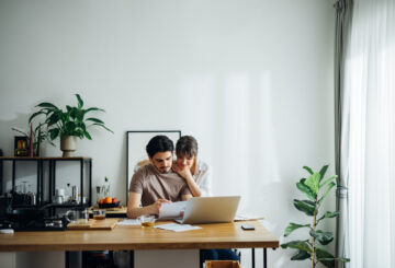 Smiling Couple Paying Bills at Home