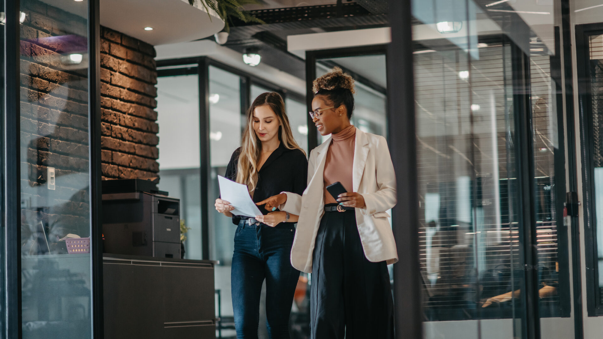 young female employees walking down the company corridor