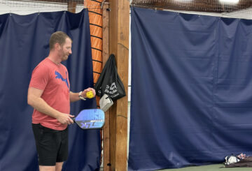 man holding pickleball racket
