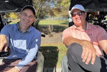 two men in golf cart