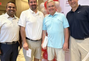 four men smiling