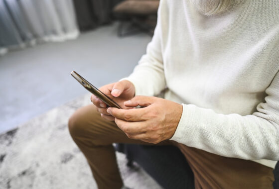Close up of hands using mobile phone.