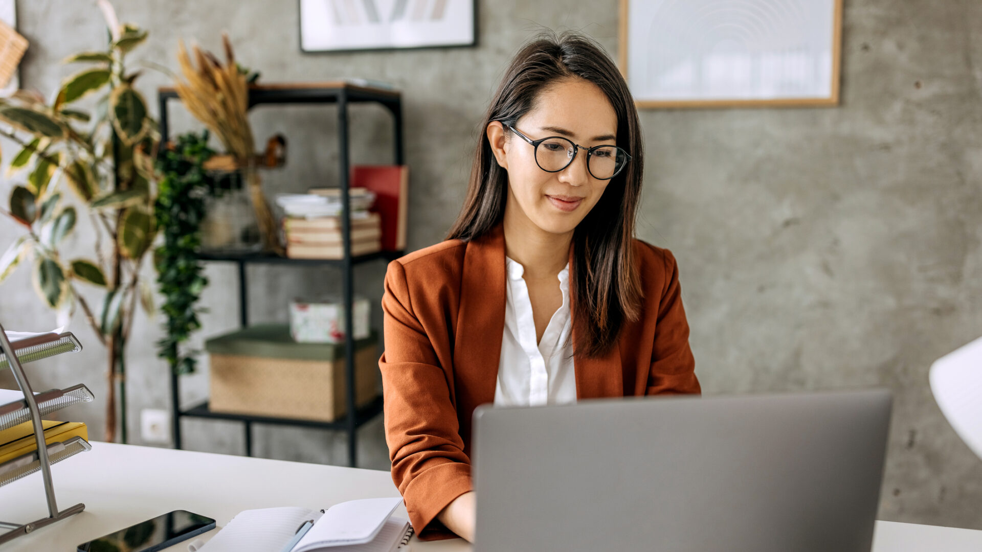 Well dressed beautiful mid adult businesswoman working from home office