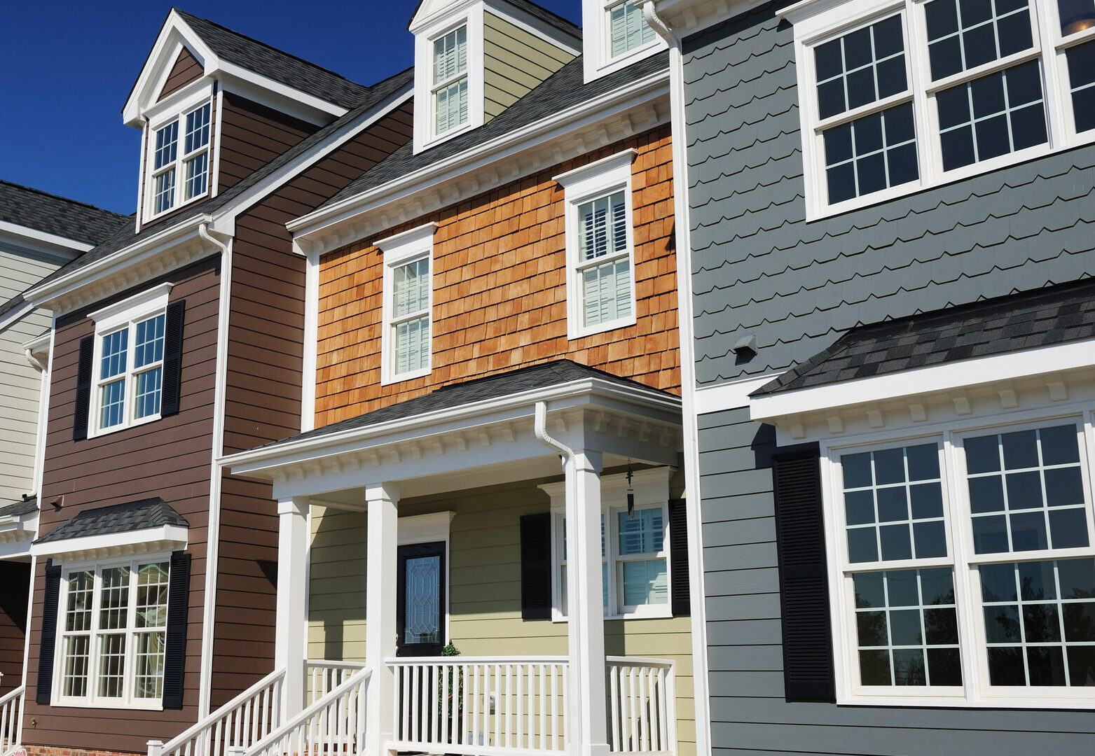 High end town homes against a stark blue sky.